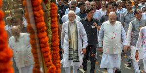 PM Narendra Modi and BJP chief Amit Shah walk along Vajpayee​'s funeral procession